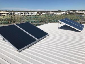 Solar hot water system panels mounted on a metal roof in Nambour