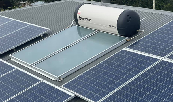 Solar hot water system installed on a metal roof alongside PV panels in Nambour